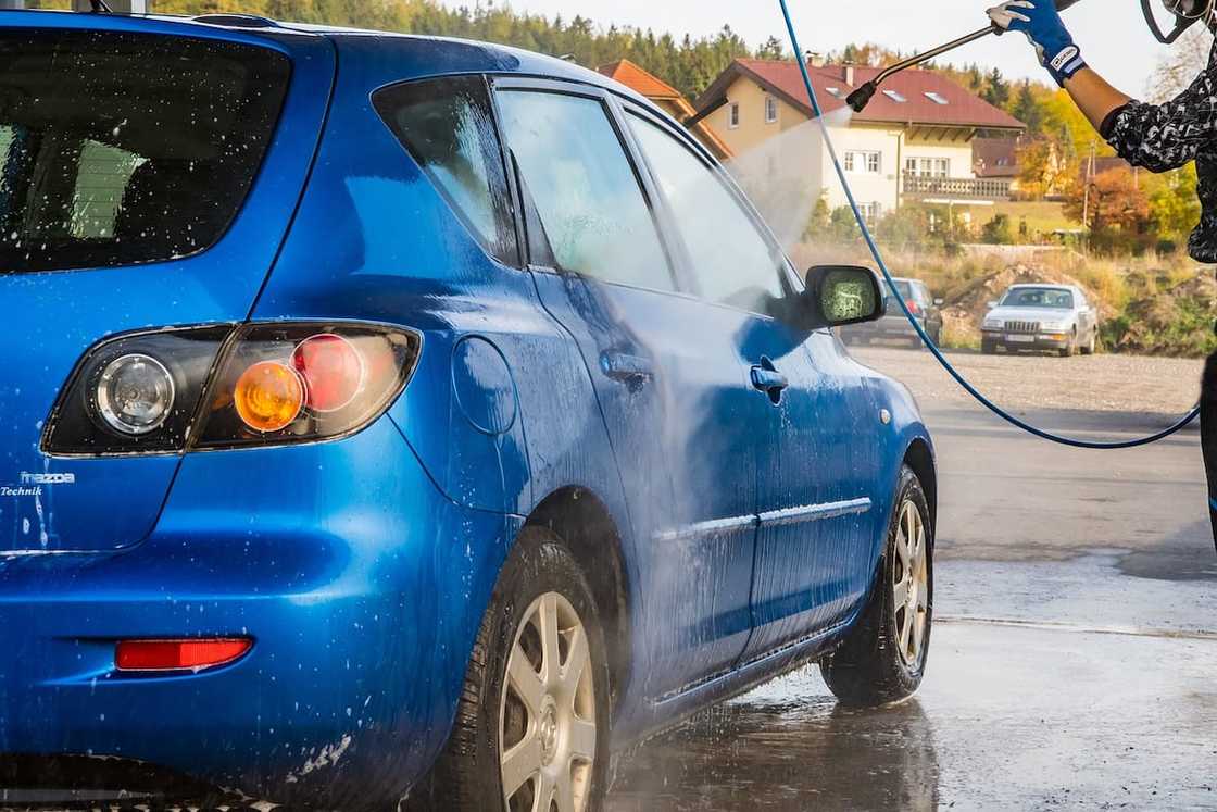 A blue car in a carwash A blue car in a carwash