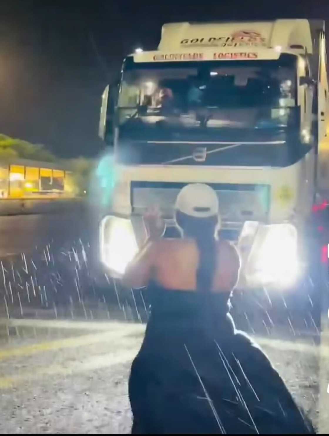 A wife stood in the rain to welcome her truck driver husband home.