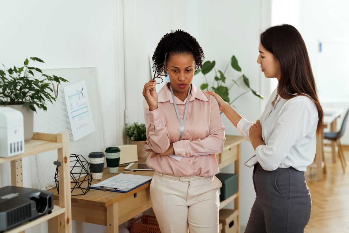 A candidate discreetly discloses information to a HR manager.