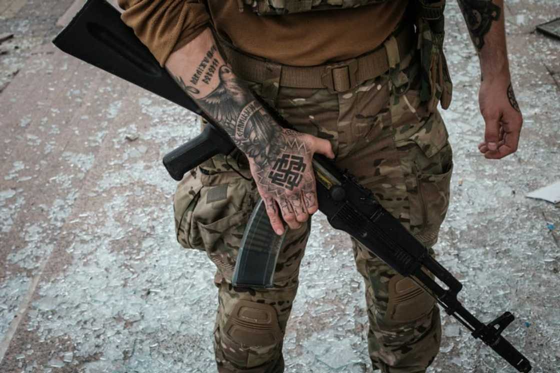 A Ukrainian soldier at the retaken station on Sunday A Ukrainian soldier at the retaken station on Sunday