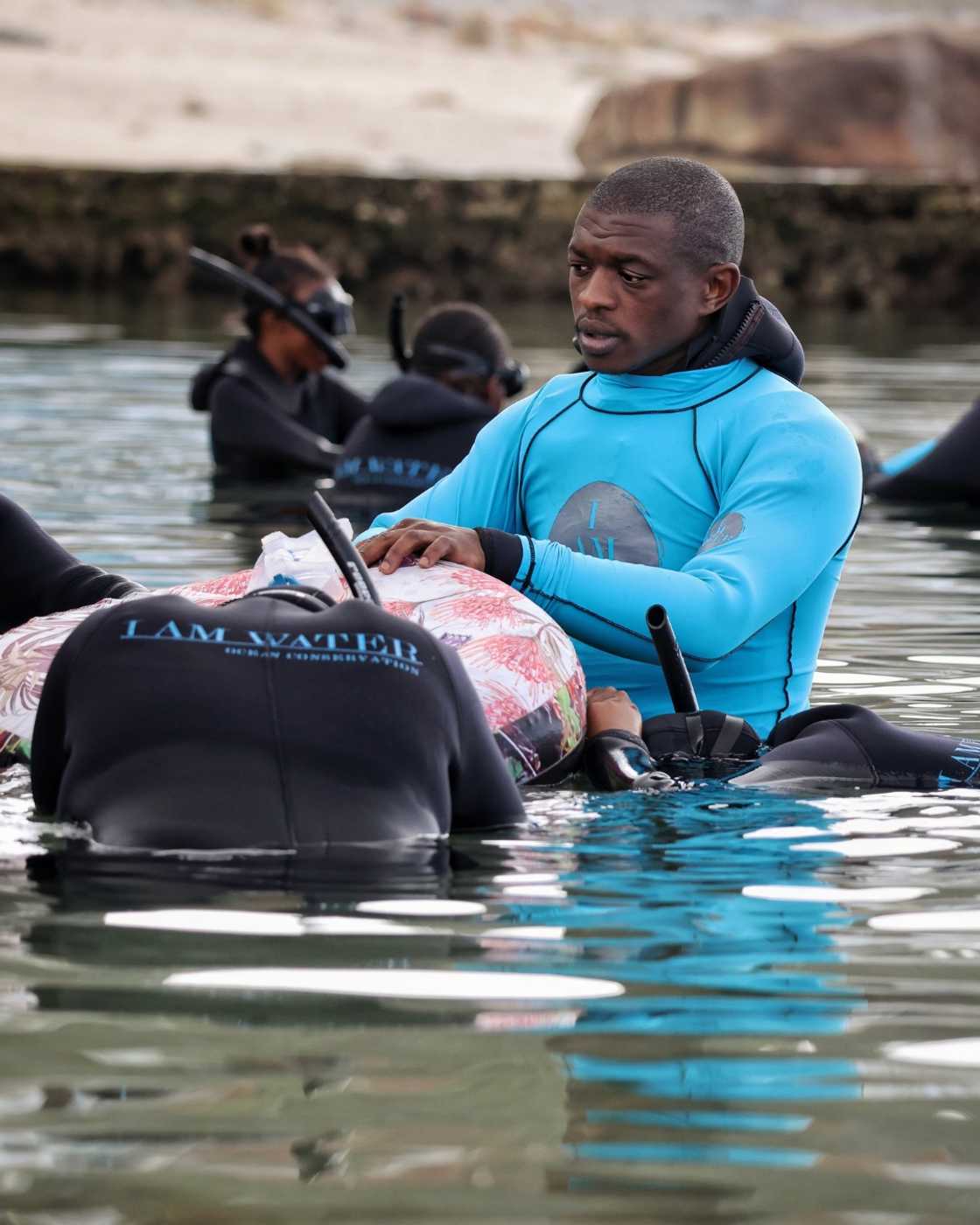 Snorkelling instructor helps participants master basics of snorkelling. Snorkelling instructor helps participants master basics of snorkelling.