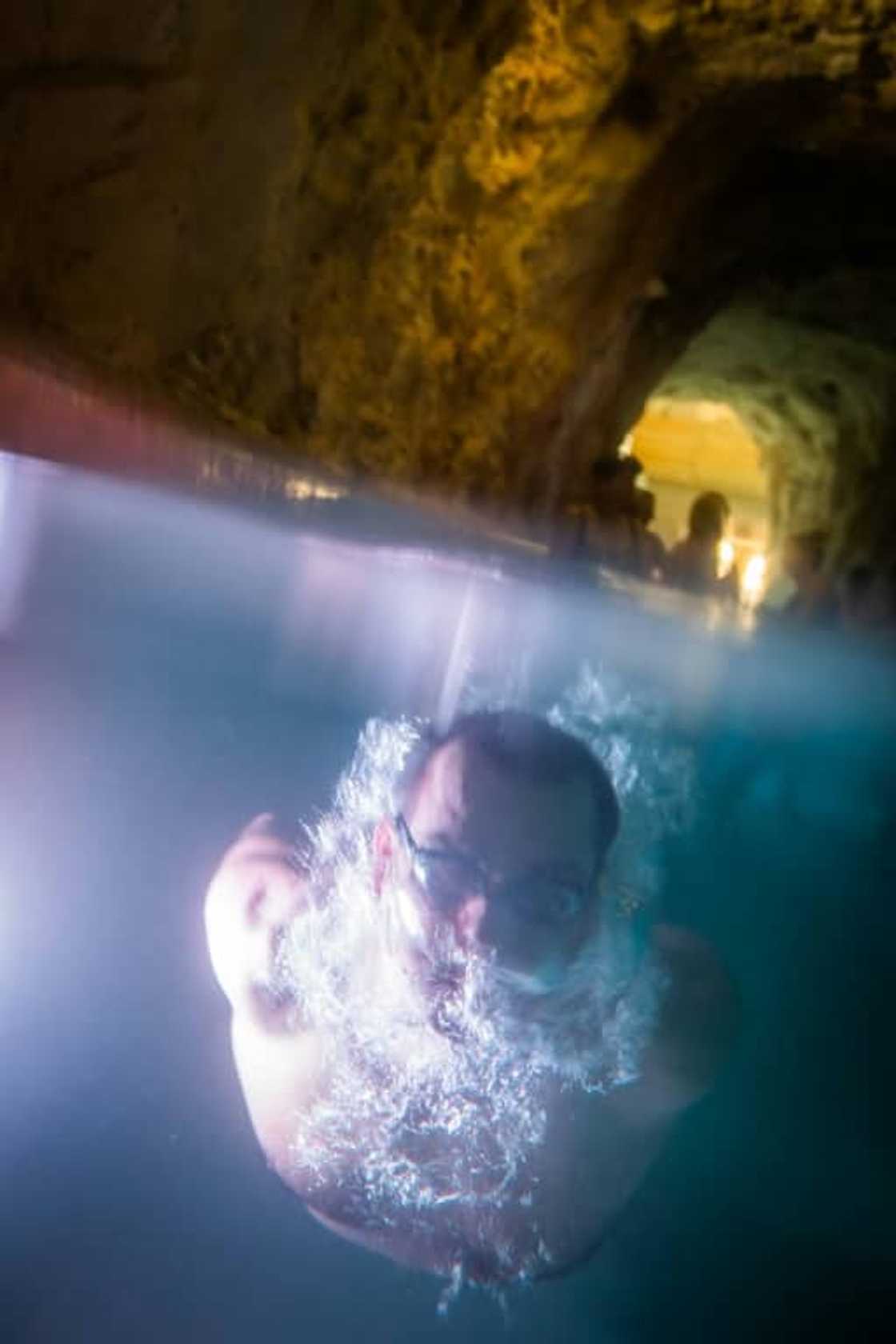 A bather swims in the Miskolctapolca cave spa complex in Hungary A bather swims in the Miskolctapolca cave spa complex in Hungary