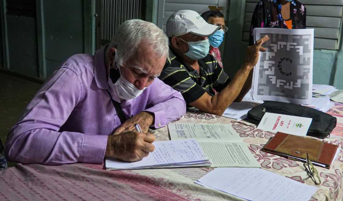 A man takes notes during a meeting called to discuss the potential new Cuban family code, in Havana province's La Lisa municipality in February 2022 A man takes notes during a meeting called to discuss the potential new Cuban family code, in Havana province's La Lisa municipality in February 2022