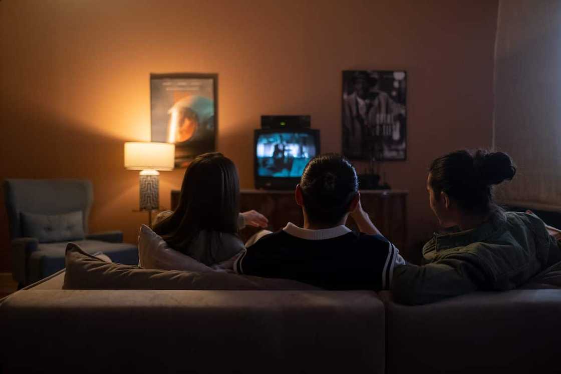Friends sitting on the couch and watching film Friends sitting on the couch and watching film
