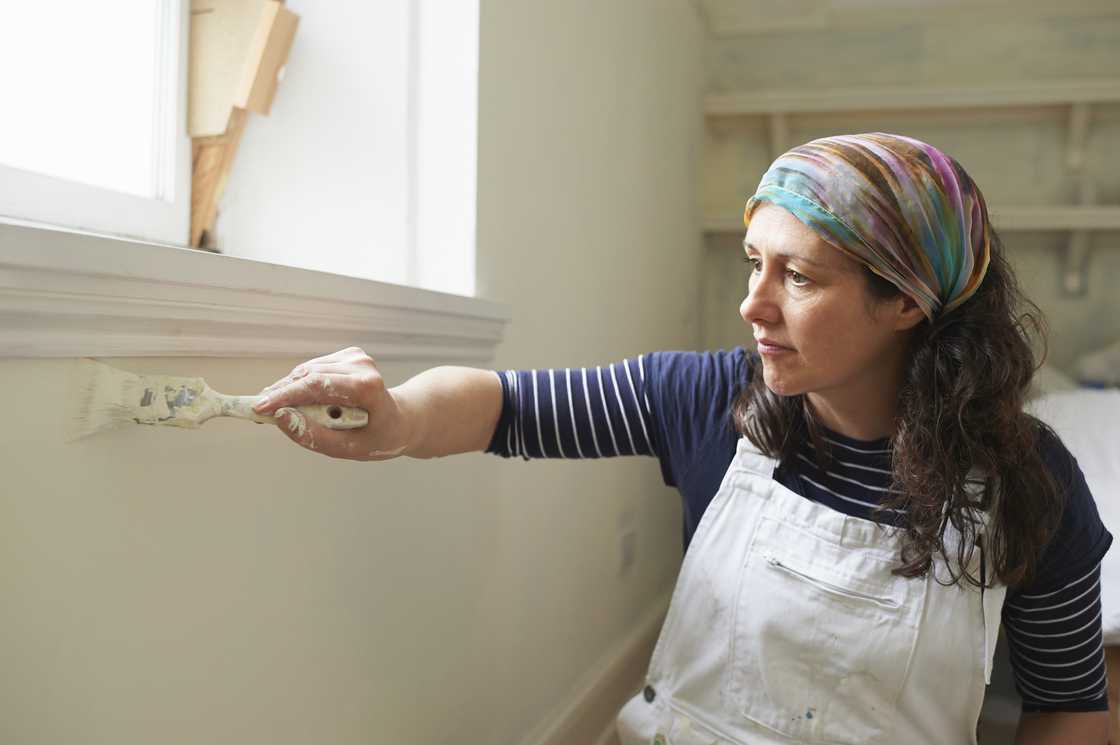 A stock photo of a woman using a brush to paint A stock photo of a woman using a brush to paint
