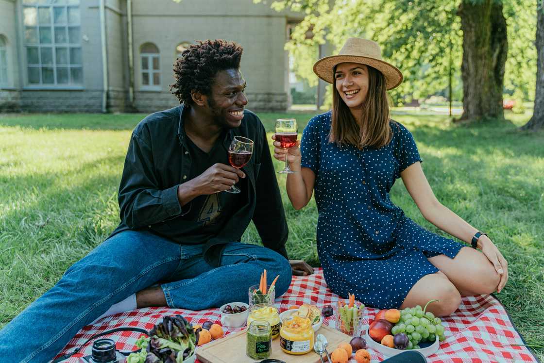 A black man and a white woman enjoying a picnic A black man and a white woman enjoying a picnic
