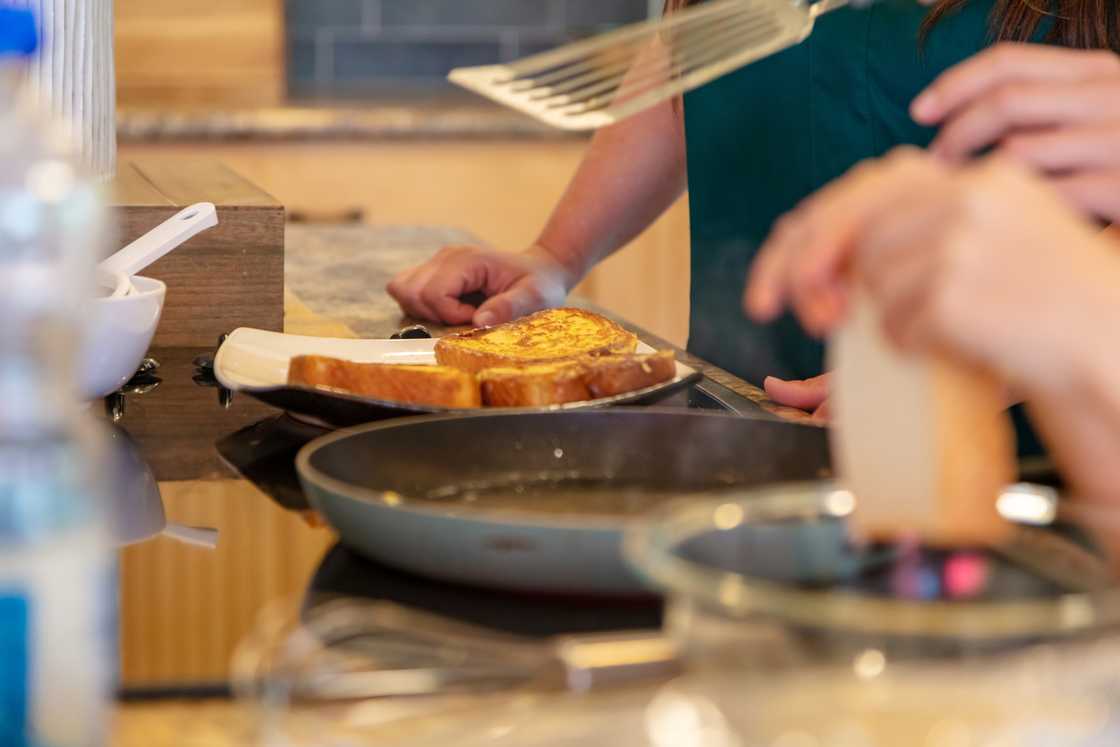 A person makes french toast