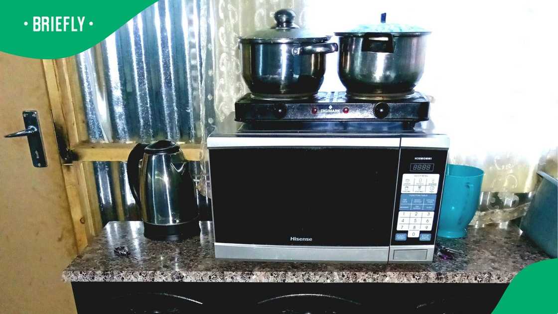 A man showed off his shack's kitchen.