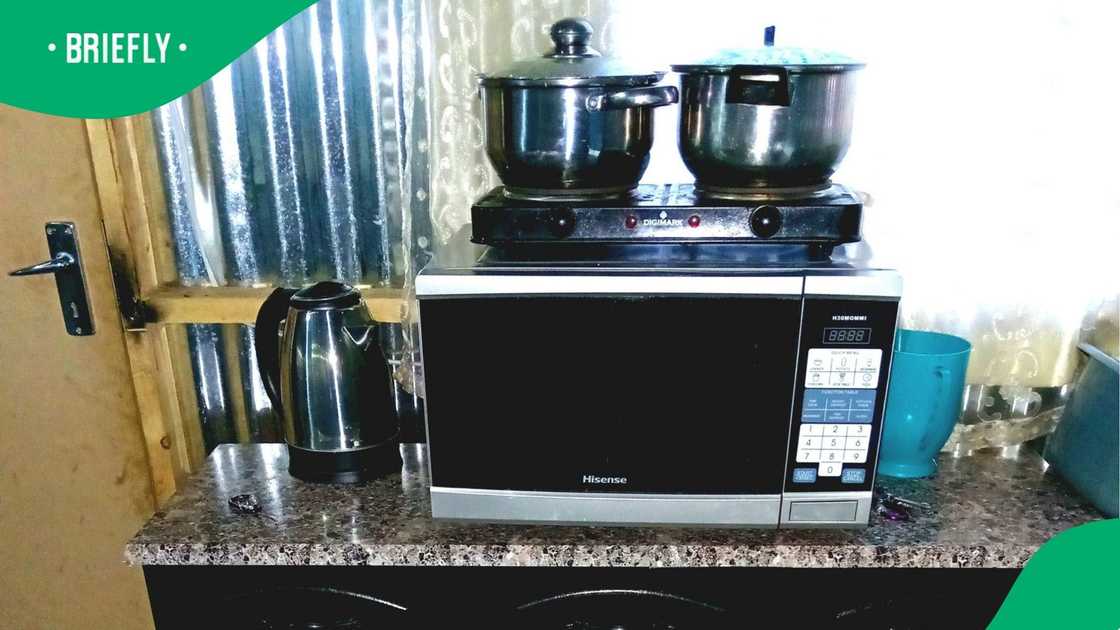 A man showed off his shack's kitchen. A man showed off his shack's kitchen.