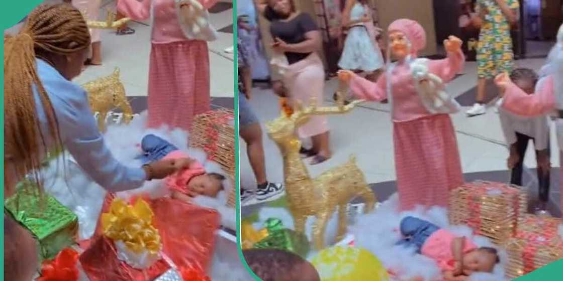 Baby catches people's attention in mall for sleeping in gift section