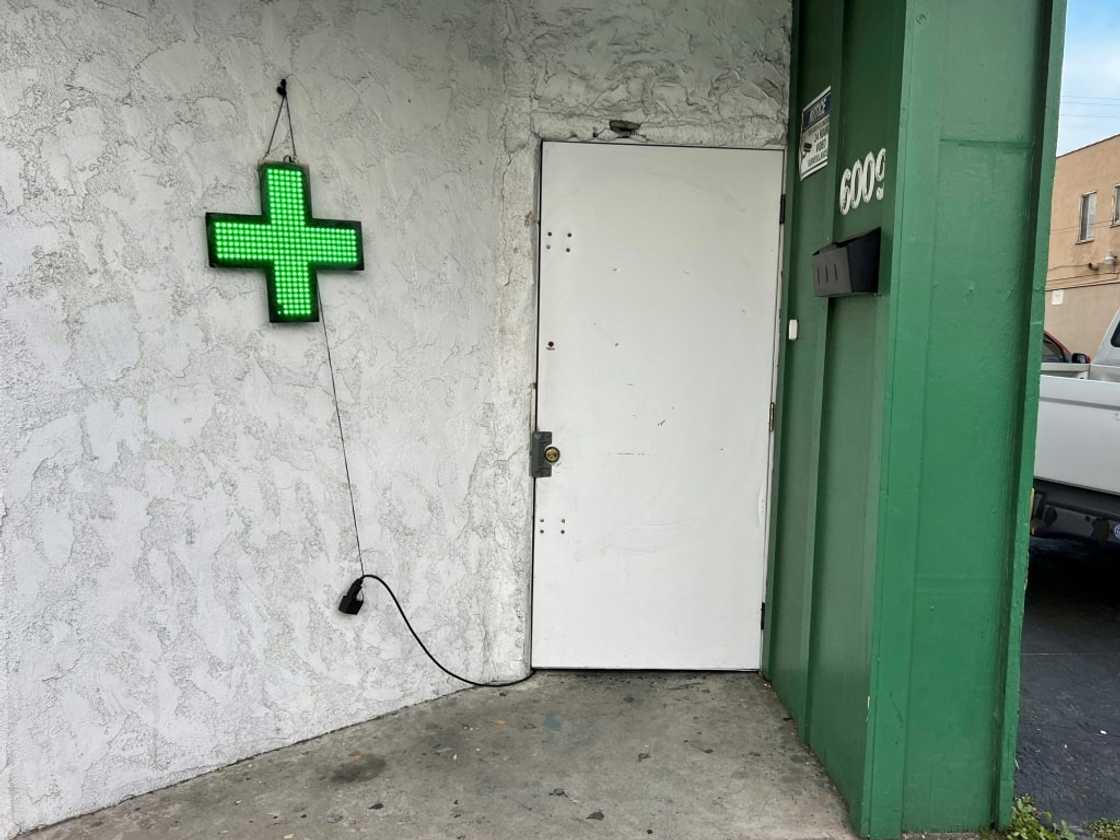 Unlicensed cannabis stores sometimes display a green cross Unlicensed cannabis stores sometimes display a green cross
