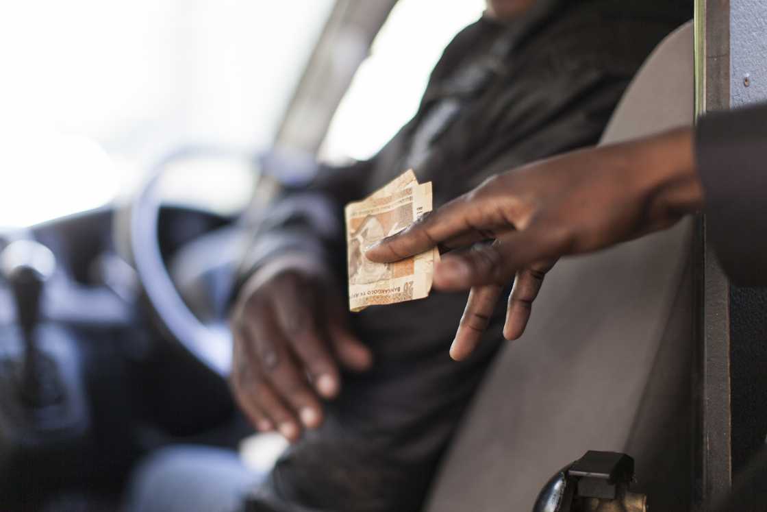 A man paying a cab driver
