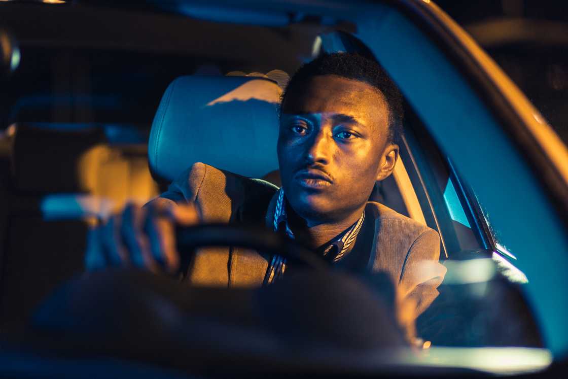 A man in a car at night