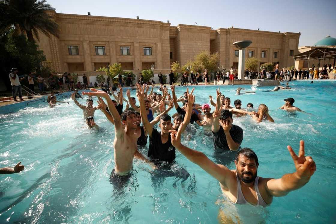 Supporters of Moqtada Sadr swim in the pool at the Republican Palace after storming the government headquarters on Monday Supporters of Moqtada Sadr swim in the pool at the Republican Palace after storming the government headquarters on Monday