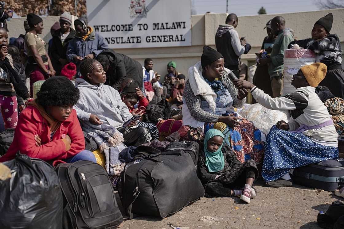 Malawian nationals wait outside the Malawian Consulate to seek repatriation amid growing fears following a surge in anti-immigrant protests and attacks in Johannesburg, South Africa, on July 13, 2026