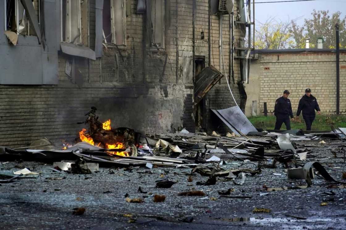 Police officers walk near the site of a car bomb explosion outside a building housing a local TV station in the Russian-held city of Melitopol in southern Ukraine Police officers walk near the site of a car bomb explosion outside a building housing a local TV station in the Russian-held city of Melitopol in southern Ukraine