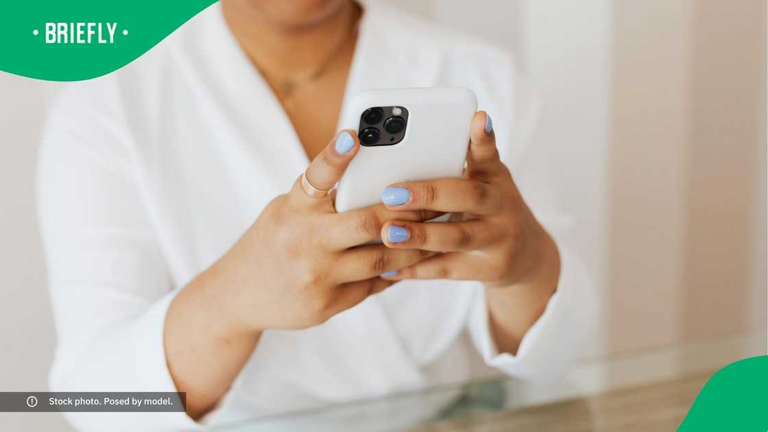 A woman typing on her phone.