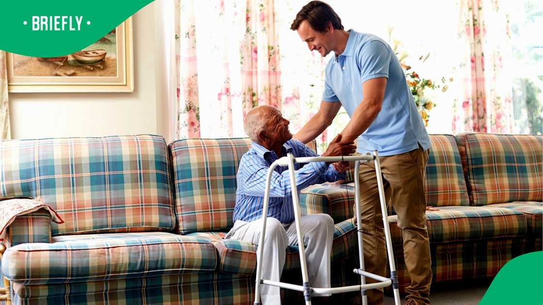 A stock photo of man helping an old man