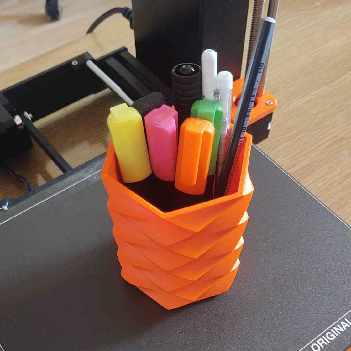 An orange pen pot An orange pen pot