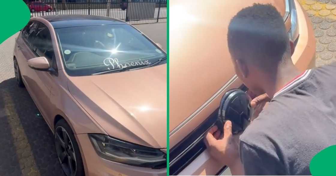 A man secured the badge on his VW car A man secured the badge on his VW car