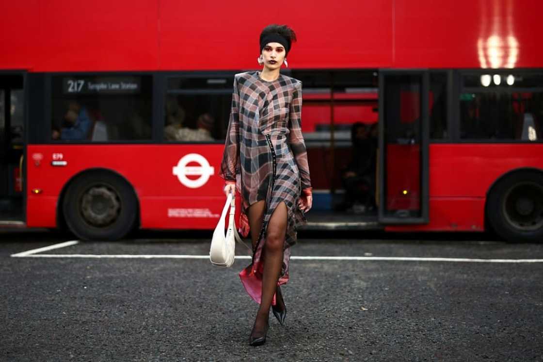 Models paraded in London's famous red double-decker buses in outfits inspired by traditional dance Models paraded in London's famous red double-decker buses in outfits inspired by traditional dance