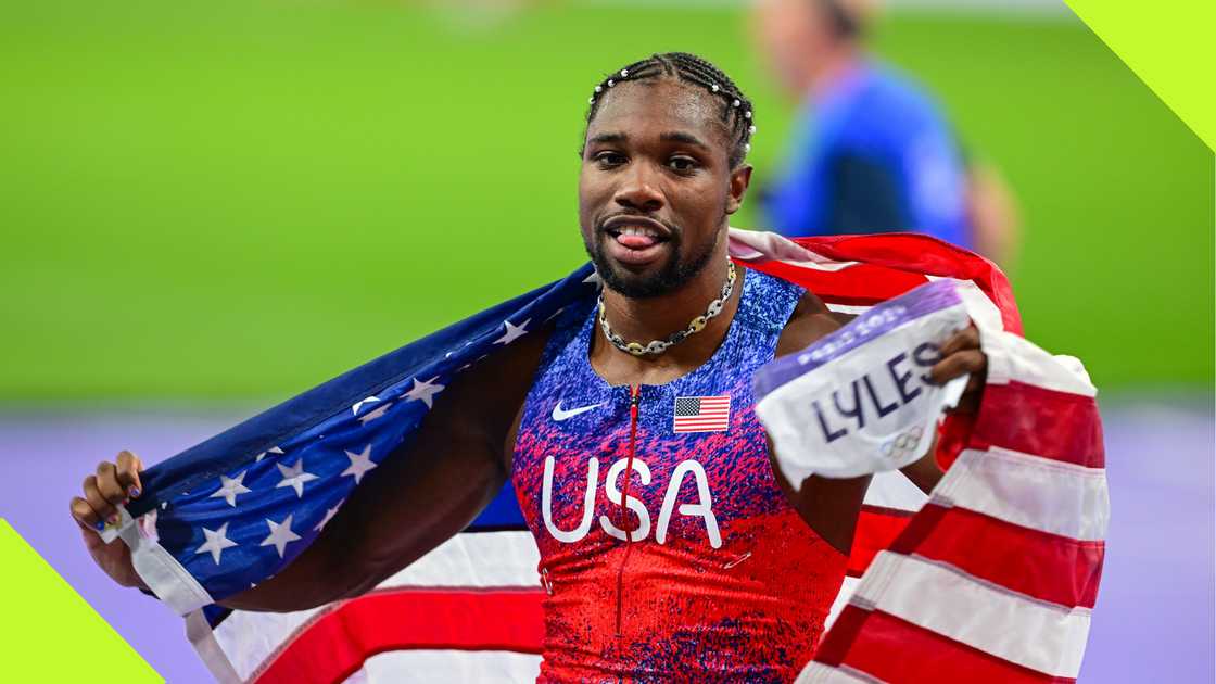 Noah Lyles flies the USA flag after winning Paris 2024 Olympics gold medal.