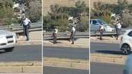 Video of Mzansi police officers playing games in uniform on the side of a highway divides citizens