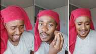 Man struggles to keep a straight face in video while trying on make-up, Mzansi laughs at the funny process