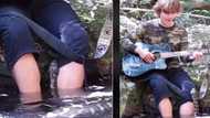 Carpet python slithers over man playing guitar next to river, curious snake visitor gets 11M TikTok views