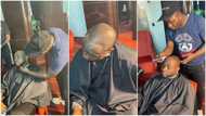 Photos and videos show man giving Davido a haircut for his birthday