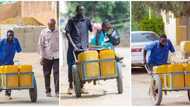 1-Armed man shows resilience in job hauling 10 water cans with a wheelbarrow