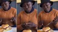 “Bathong”: Mzansi in stitches and react to video of a lady eating burger with fork & knife