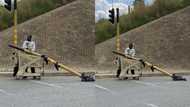 Mzansi left divided by man taking traffic light using a trolley