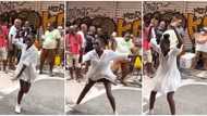 Lady in white dress keeps legs apart, shows off sweet dance moves on street, people fight over her in video