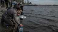 Kherson residents seek water and phone service on river's edge