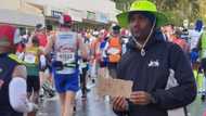 Man holds Uber sign along Comrades route just in case runner decided they needed a lift, pic has SA busting