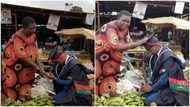 Young man kneels for his mum in the market, appreciates her for sending him to school, photos go viral