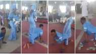 Cash rains as paraplegic man dance-crawls with wife to the altar for their child's dedication