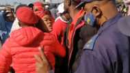 Police separate EFF and Operation Dudula members outside Soweto tavern massacre site