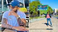 Proud man shows off a giant billboard with his face on it and the people of South Africa help hype him up