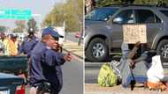 Johannesburg metro police remove women who beg from the side of the road, contravening by-laws