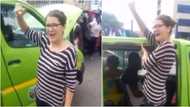 Reactions as video of white lady serving as taxi assistant surfaces