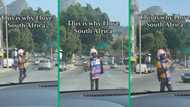 Cape Town pamphlet distributor in pink wig and tights brings smiles to drivers with upbeat energy