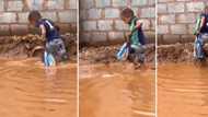 TikTok video of little boy walking home in flooded street with loaf of bread touches Mzansi's heart