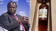 Tito Mboweni shows off the only birthday gift he received, a bottle of scotch whiskey worth R3 500