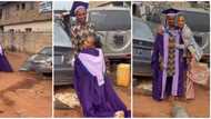Graduate runs to her father's mechanic workshop, hugs and dresses him in her graduation clothes in clip