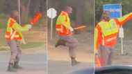 Traffic cop aces his job while entertaining motorists with fresh moves in hilarious clip