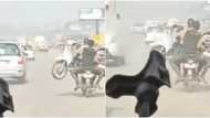 Only in Africa: Man on motorbike transports another bike on his lap, no problem