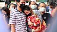 Distraught parents lay white roses for Thai nursery massacre victims