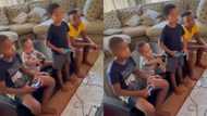 Siblings play cute console game control trick on fun loving toddler